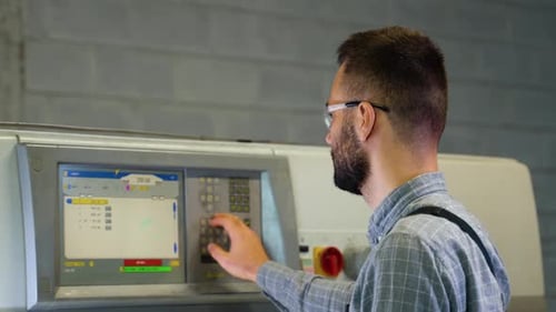 Print House Worker Setting Parameters on Modern Offset Printing Machine