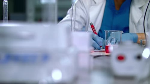 Scientist Working in Laboratory With Beakers and Test