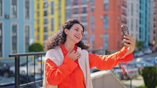 Happy Woman Making Video Call on Smartphone in the City