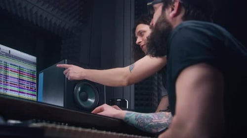 Audio Engineer and Male Singer Create Song in Recording Studio
