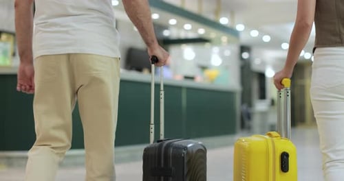 Close Up Tourists Arriving with Suitcase at Hotel Front Desk Two People with Luggage Checking in