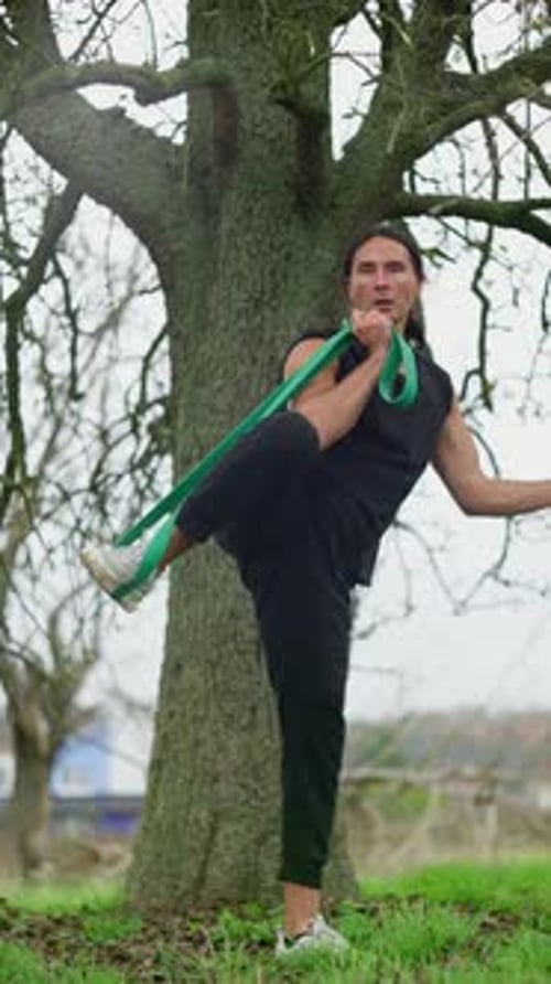 Athlete Stretching with Band in Nature