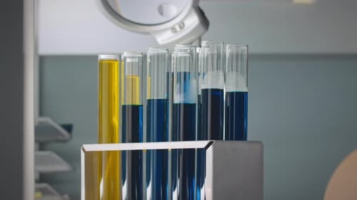 Test Tubes with Yellow and Blue Liquid in Lab