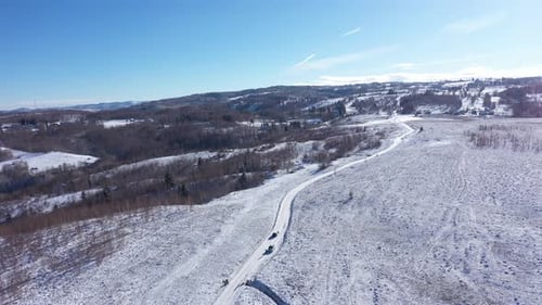 Aerial View of Car Driving on a Winter Road. Winter Countryside Landscape