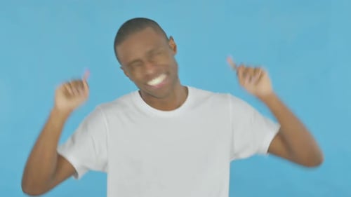 African Man Dancing on Blue Background