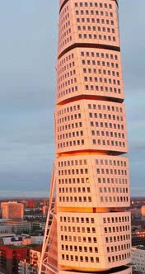 Aerial drone view of Turning Torso residential skyscraper in Malmo, Sweden at sunset. Vertical