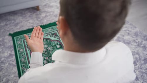 Adult Praying on Rug in Home Setting