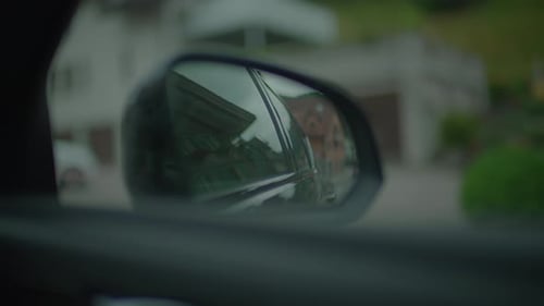 POV View Of Car Mirror Driving On Urban City Road