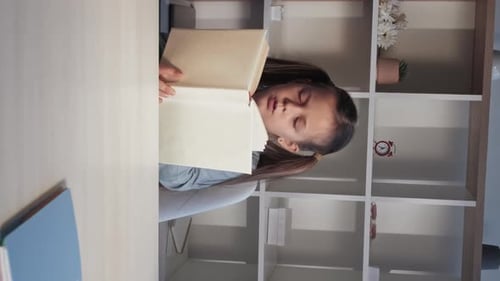 Girl Sleeping With Book On Desk