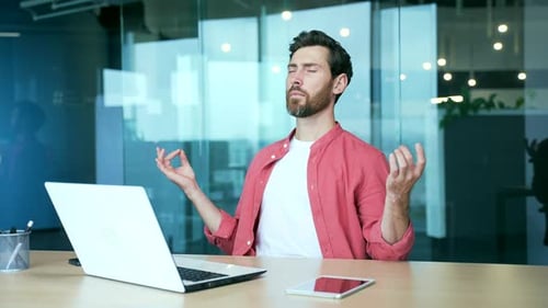 Man Meditating at Desk in Workplace Office