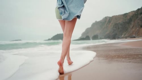 Cheerful Young Woman Running on Sandy Beach By Sea