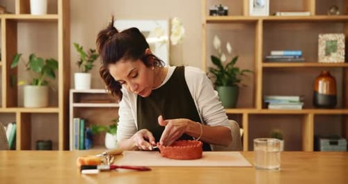 Woman, clay and bowl for pottery, workshop and creative art in ceramic store with tools