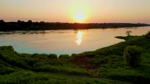 Cinematic Sundown Over River with Sun Reflection in Summer Water