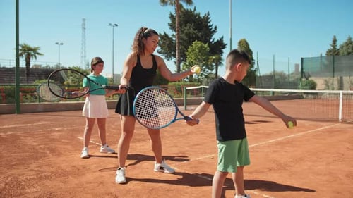 Tennis Lesson with Coach and Young Students