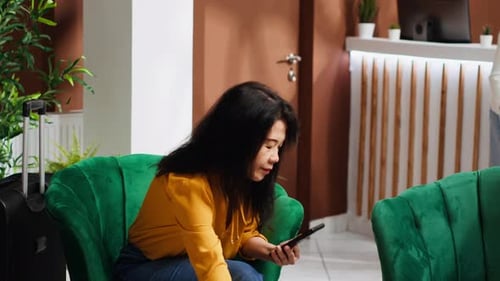 Woman Traveler Waiting to Register at Five Star Hotel