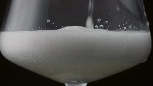 Foamy Drink Poured into a Tall Clear Glass
