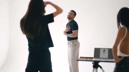 Professional Photoshoot with Model and Photographers in White Studio