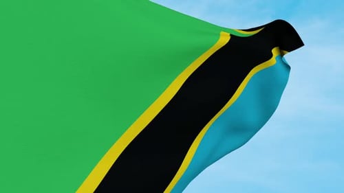 Realistic Waving Tanzania Flag Against Blue Sky