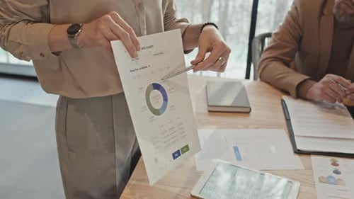 Adults Reviewing Data During Corporate Meeting