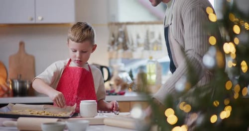 Child and Adult Baking Cookies at Christmas Time