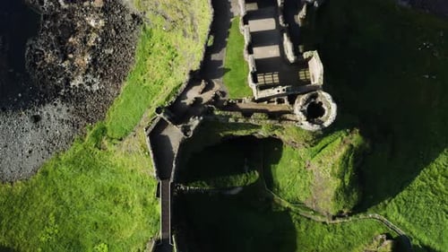 Ireland Dunluce Castle with Medieval Historical Architecture - Overhead Aerial Drone View
