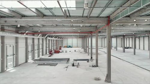 Horizontal Drone Shooting of Contemporary Logistics Hub Indoors Aerial View of Empty Industrial