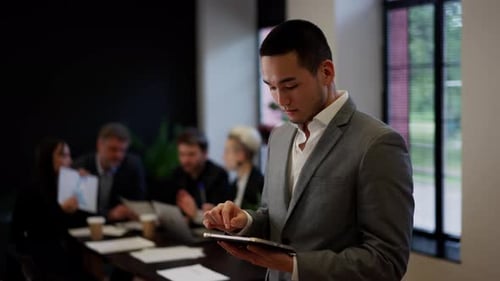 Asian Successful Businessman on Teambuilding Young Man Office Worker Using Tablet in Front of Team