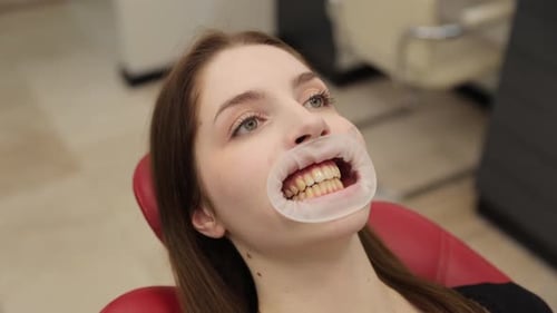 A Patient is Receiving a Dental Procedure in a Modern Clinic Showcasing the Advancements in Dental