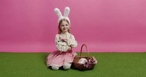 Smiling Girl Holding Rabbit with Basket and Flowers