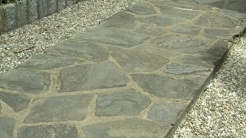 A formal style pathway of flagstones in a Japanese garden.