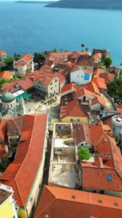 Aerial, drone view of buildings on the shore of the Adriatic sea in Croatia. Vertical