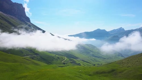 Clouds Billowing Down From the Mountains in a Picturesque Valley Landscape