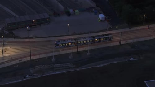 High Angle View of Modern Streetcar Leaving Tram Stop and Passing Through Evening City Oslo Norway
