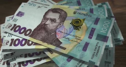 Ukraine Hryvnia 1000 money banknotes falling on the table