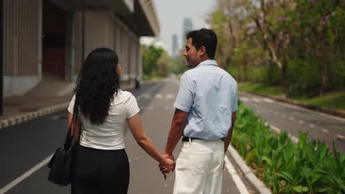 Romantic Couple Holding Hands Walking on City Sidewalk