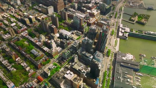 Beautiful quarters of Manhattan island near the river bank. Top view of the city with busy traffic.