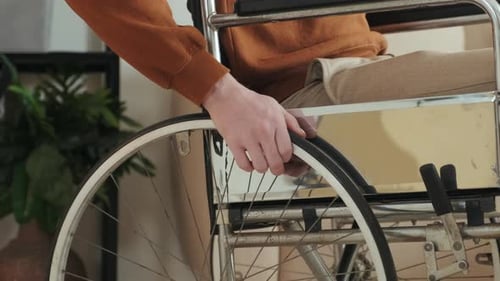 Man with Disability Riding Wheelchair Close Up