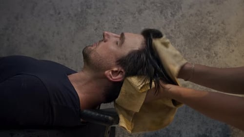 Man Relaxing While Drying Hair at Salon