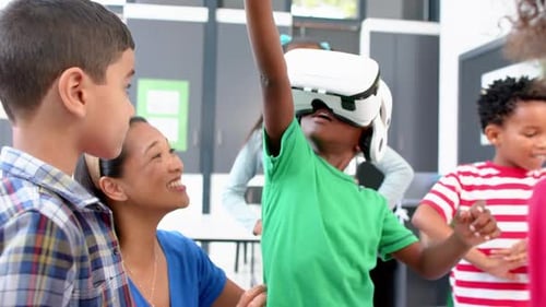 In school, children using VR headset with teacher guiding them in classroom
