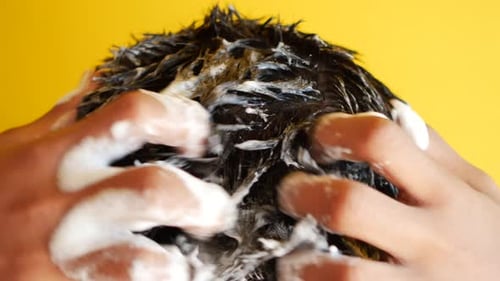 Young Men Washes h His Hair with Shampoo
