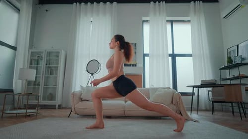 Woman Doing Yoga Lunge Exercise at Home