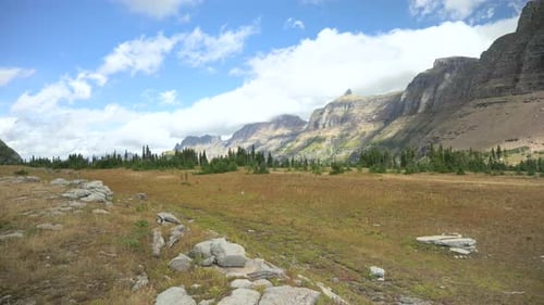 Standing on the Hidden Lake Trail looking down the Mount Oberlin range at Logan Pass Visitor center