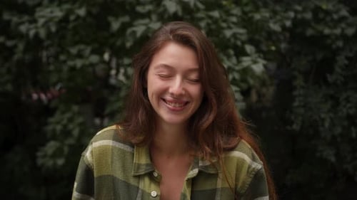 Smiling Young Woman With Brown Hair Outdoors