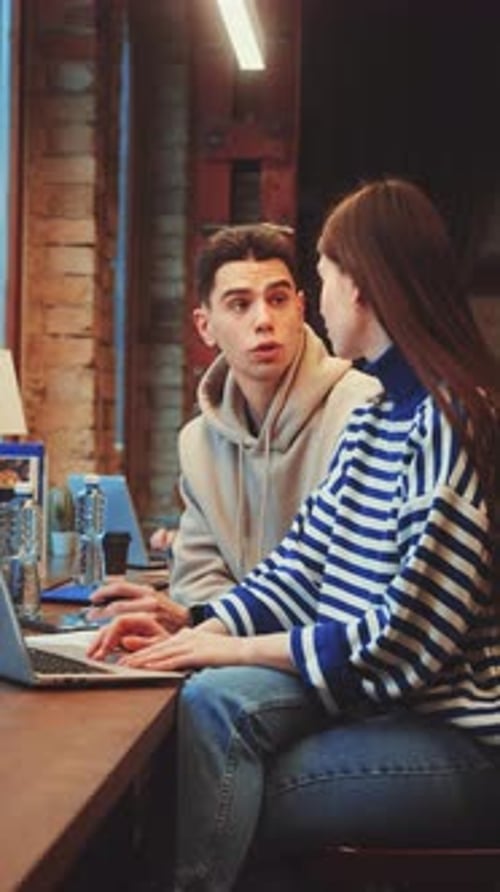 Vertical Screen Students Collaborating at Library Desks