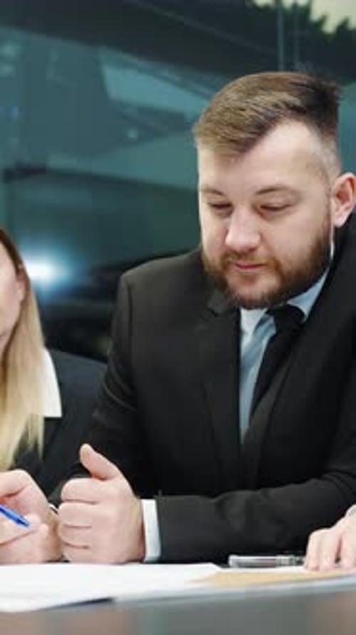 Businessman Discussing Documents in an Office Environment