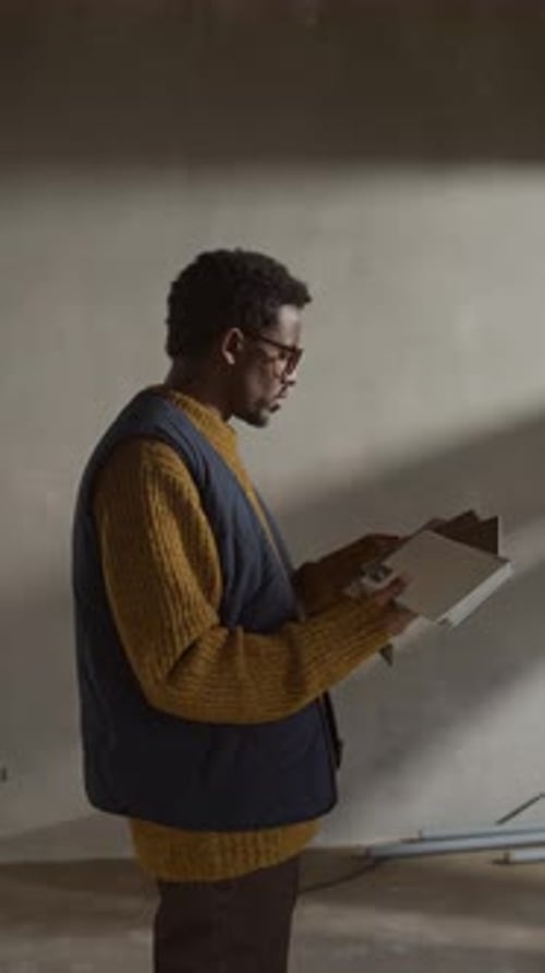 Black Architect with Samples at Unfinished Construction Site