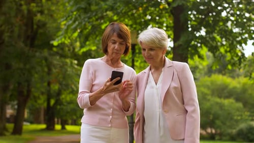 Two women taking a selfie in the park