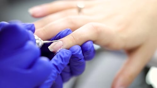 Close Up of Manicurist Filing Nails