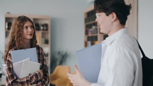 University students talking and studying in a modern library