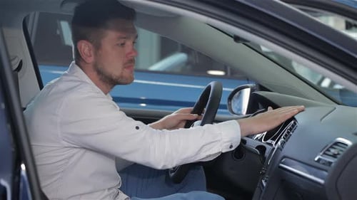 Man Examines Car Interior at the Dealership